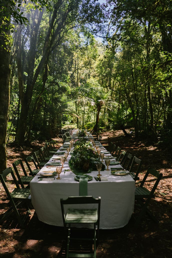 Convidados à mesa entre as árvores
